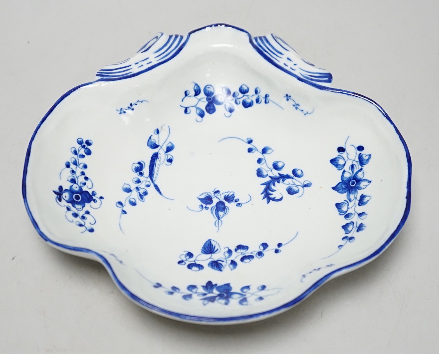 An 18th century Caughley shell dish painted with Bright, Sprigs, impressed Salopian, 19.5cm wide